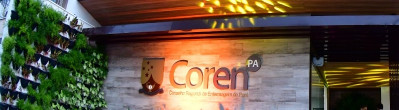 Fachada do prédio do Conselho Regional de Enfermagem do Pará (Coren-PA), com design moderno e iluminação destacada.